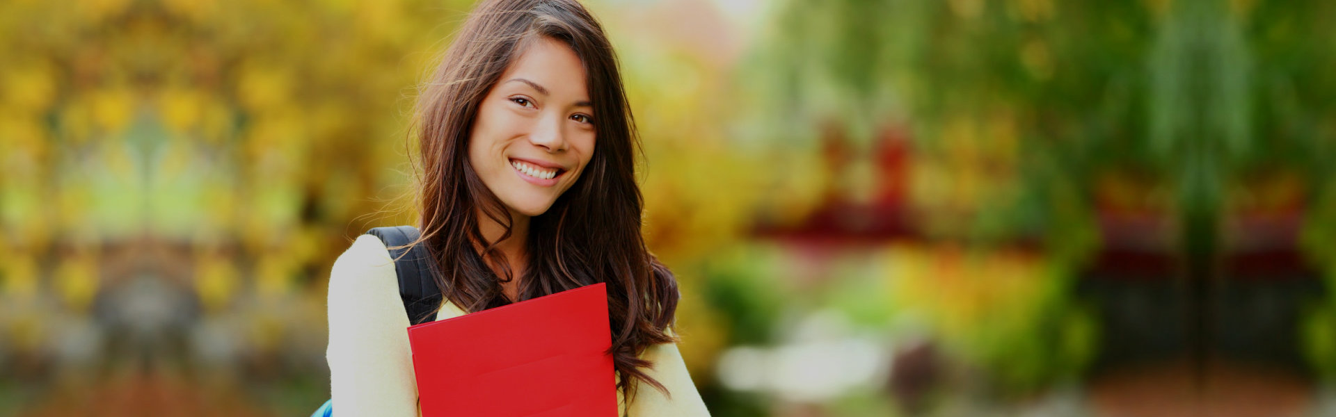 Young student girl holding a book